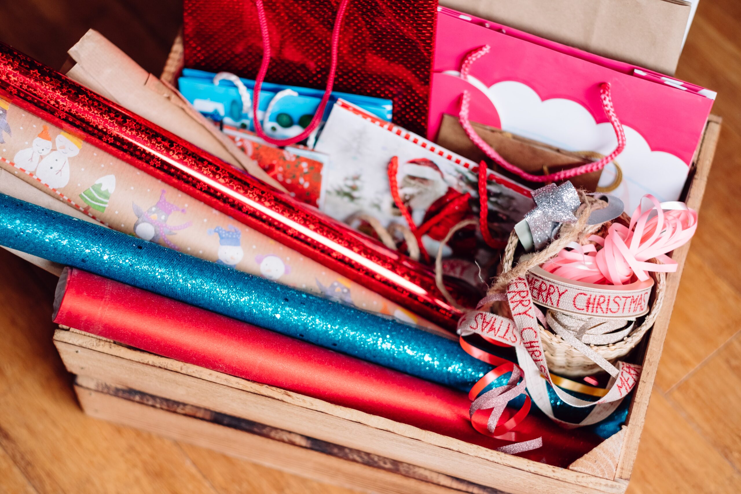 Gift wrapping supplies in a wooden crate